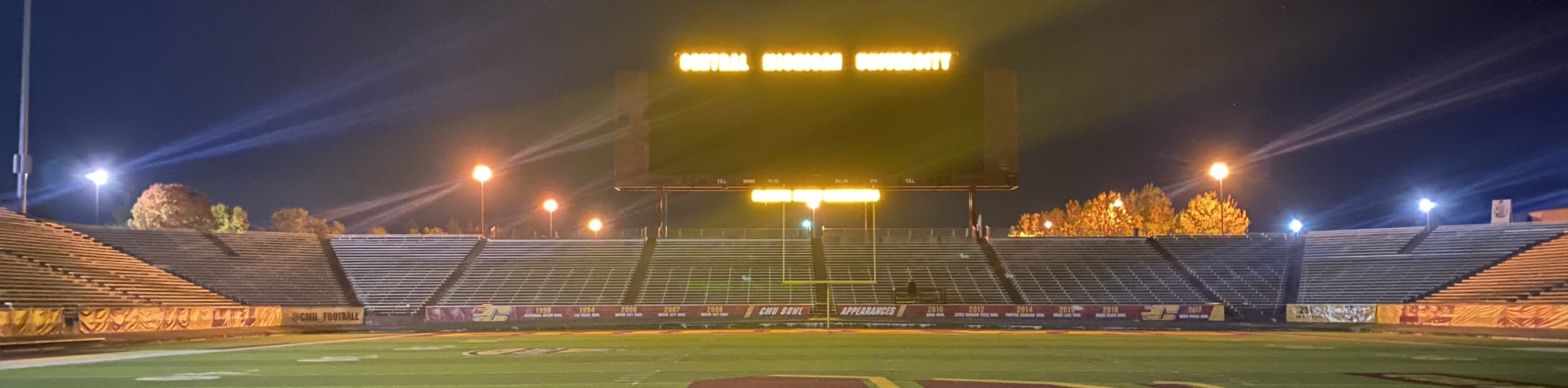 empty football stadium at night under the lights Greensboro