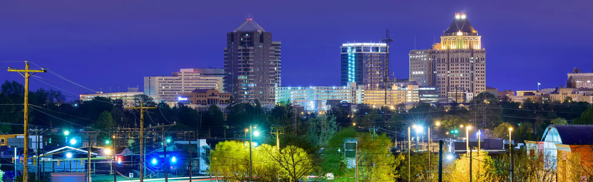 Neon color image of a band playing and people singing along