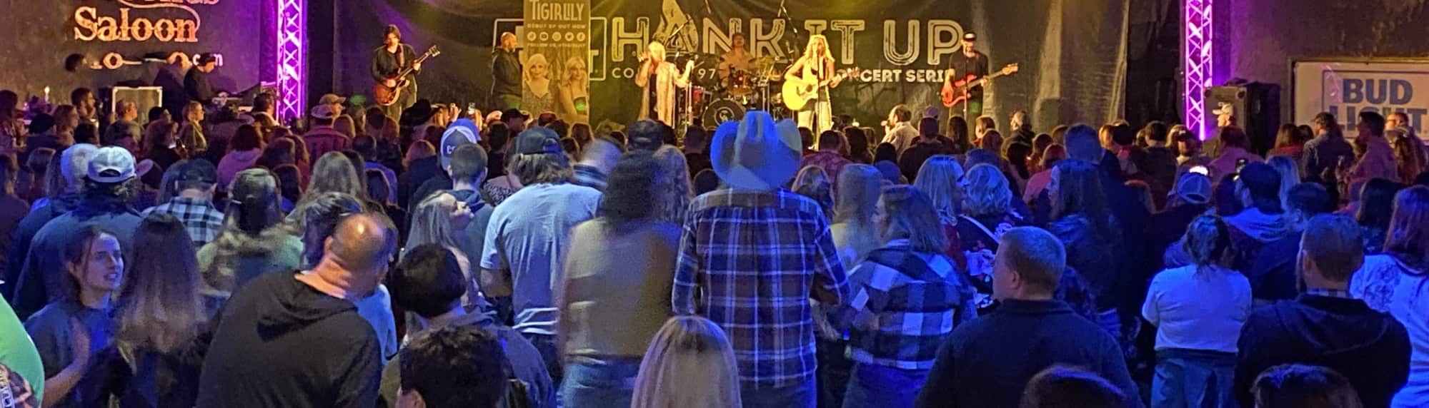 country concert with fans wearing cowboy hats Greensboro